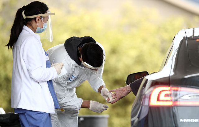 BOLINAS, CALIFORNIA - APRIL 20: A medical professional administers a coronavirus (covid-19) test at a drive thru testing location conducted by staffers from University of California, San Francisco Medical Center (UCSF) in the parking lot of the Bolinas Fire Department April 20, 2020 in Bolinas, California. The town of Bolinas, with a population of 1600, is attempting to test the entire town for COVID-19. The test had two components - the first is a blood test that will look for antibodies, and the second is a mouth and throat swab that can detect active coronavirus infections.