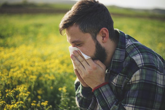 man reacting to spring allergies