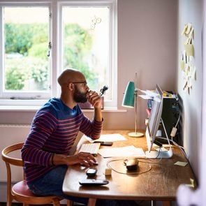 side view of young man working from home