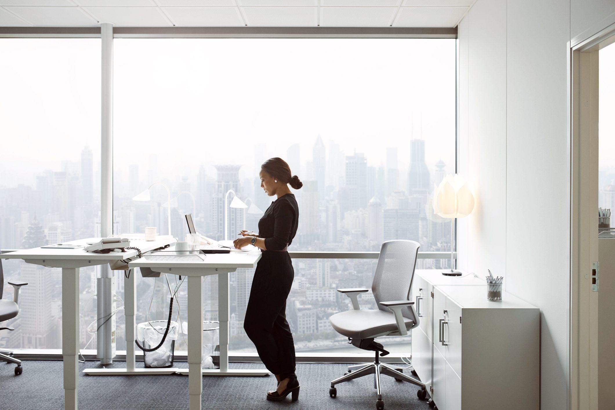woman using standing desk at work