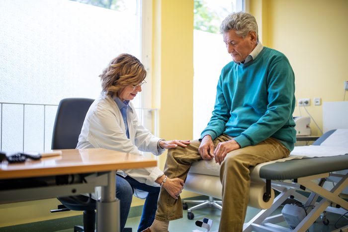 doctor examining patient's arthritis condition