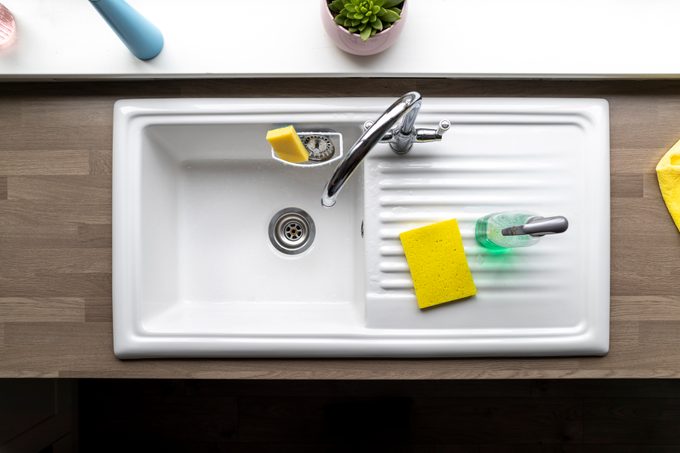 directly above shot of clean kitchen sink with sponges