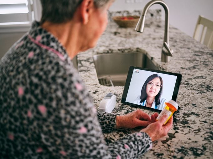 telemedicine concept; woman on video call with doctor