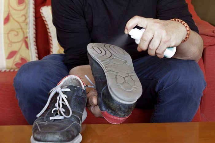 man disinfecting shoes to protect against coronavirus
