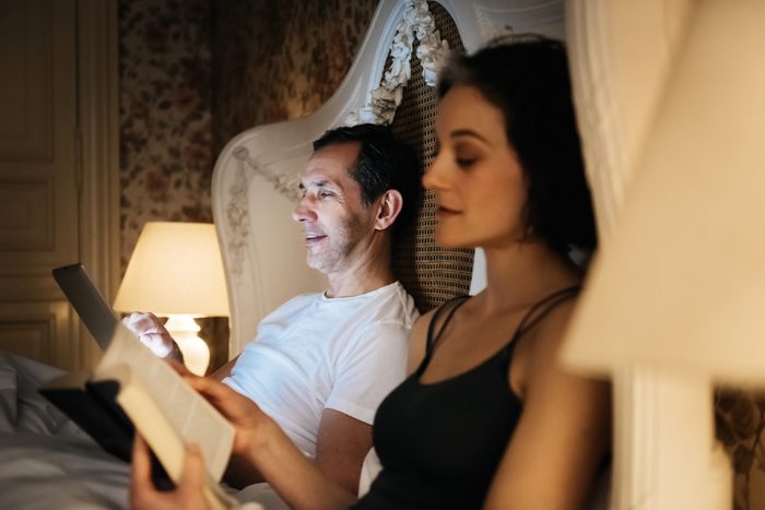 couple reading in bed before going to sleep