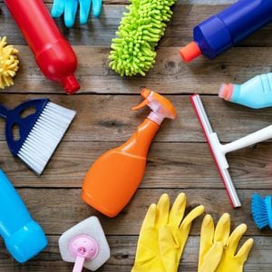 cleaning tools spray bottle gloves House cleaning product on wood table