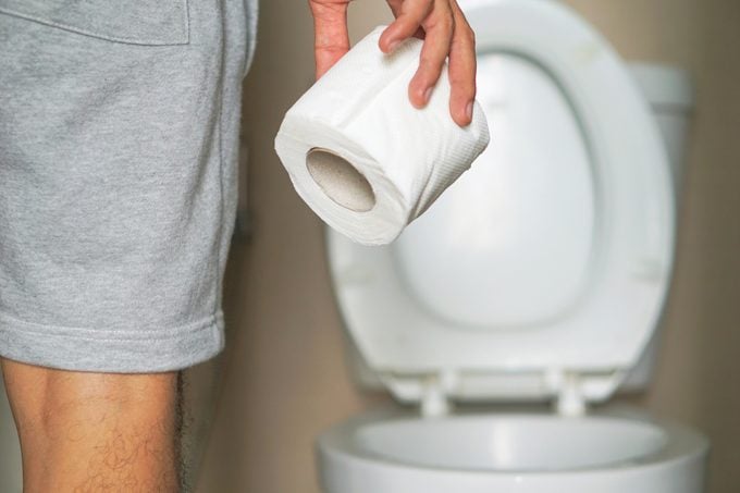 man holding roll of toilet paper