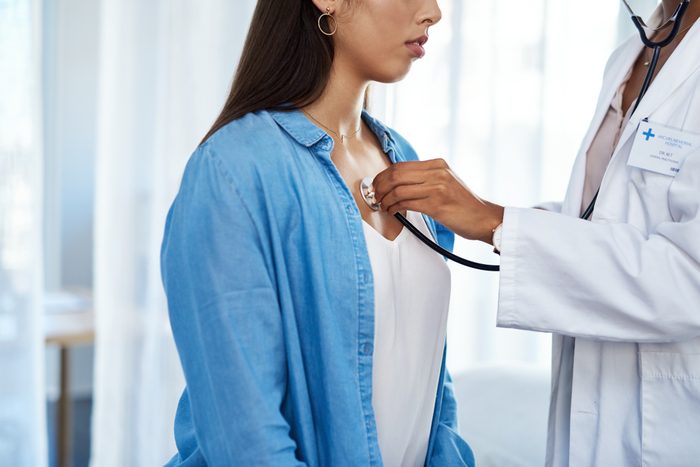 cropped shot of doctor listening to patient's heart and lungs