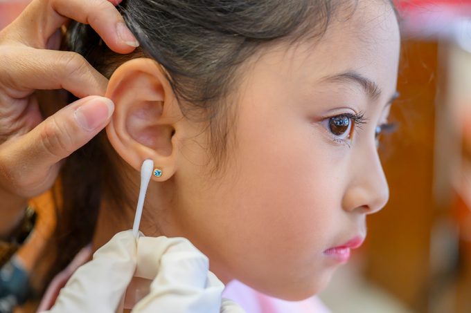 little girl getting her ears pierced