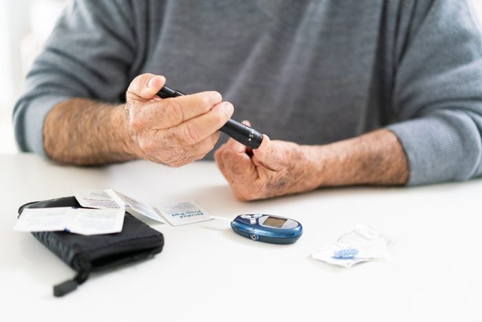 man with diabetes taking blood sugar