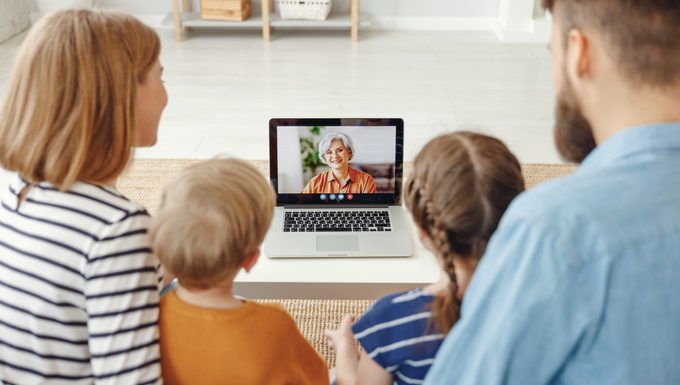family talking to grandma on laptop video call