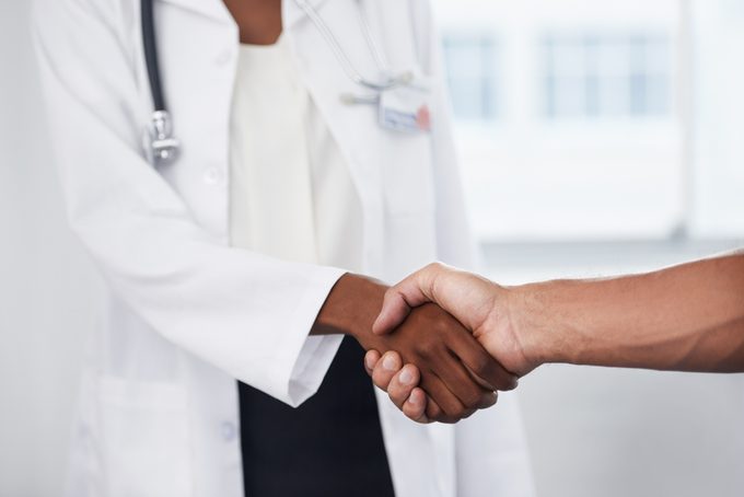 close up shot of doctor and patient shaking hands