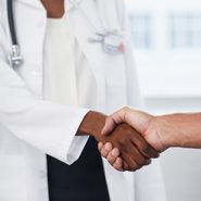 close up shot of doctor and patient shaking hands