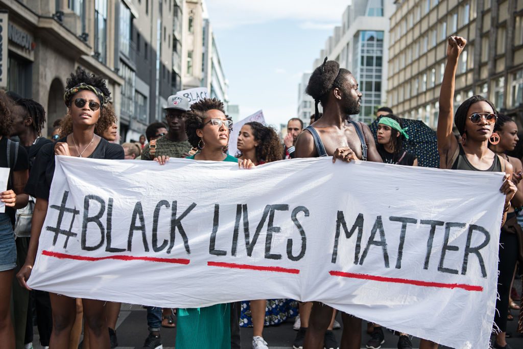 protestors holding black lives matter sign