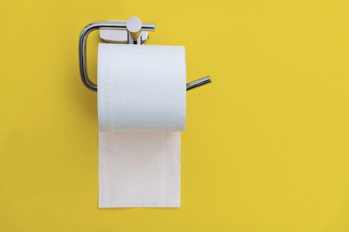 toilet paper holder on yellow background