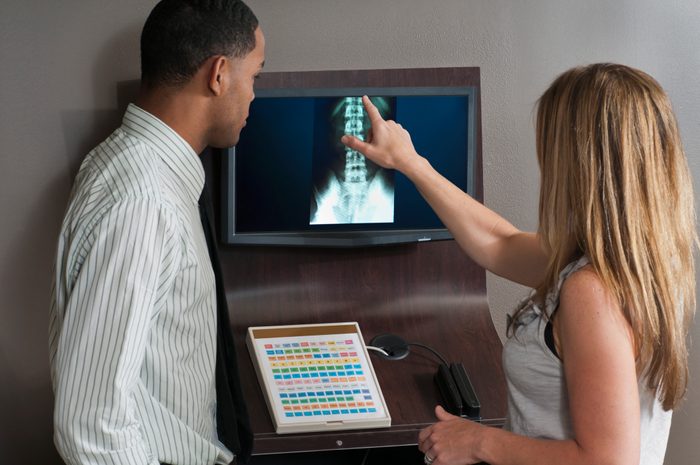 Chiropractor Showing Xrays to Patient