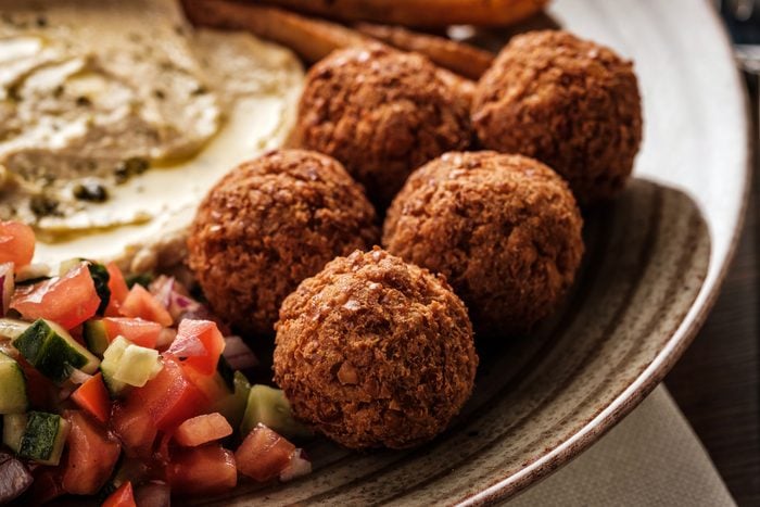 Close-up of Traditional falafel balls with salad and hummus on a plate