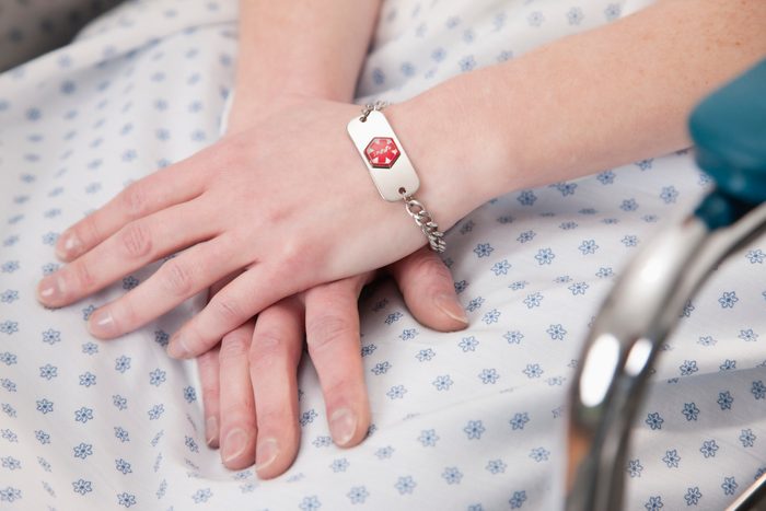 USA, Illinois, Metamora, Close-up of female patient hands with medical identity bracelet