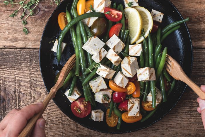 Vegan meal, cooking green beans salad with grilled tofu