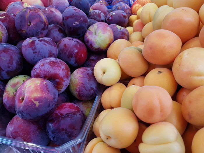 Plums and apricots at the market, in summer