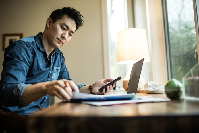 man working on finances at home