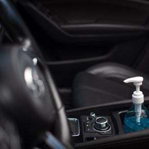 Bottle of blue sanitizer ethyl alcohol hand gel cleanser put in the car, prepare for protecting coronavirus, COVID-19