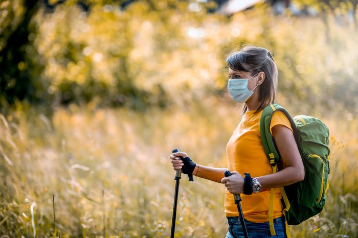 woman taking a hike with face mask on