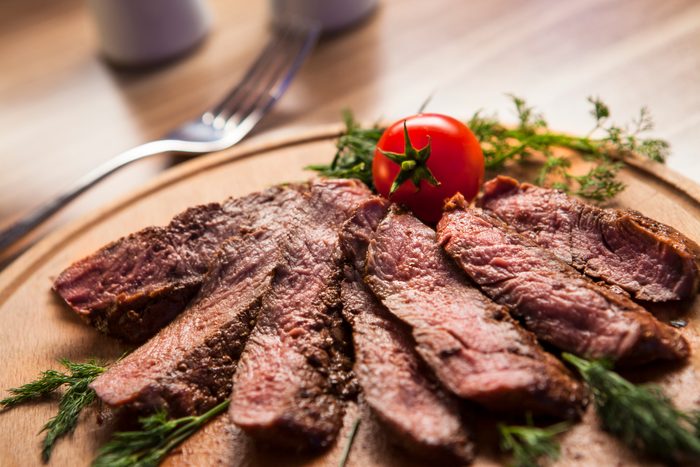 grilled steak on wood plate