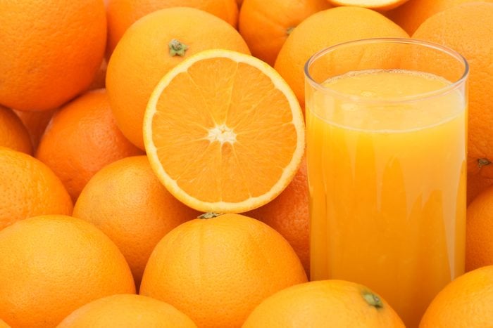 orange juice and oranges full frame