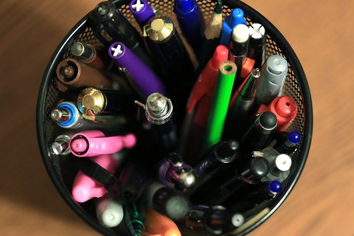 High angle view of a container of various pens and pencils