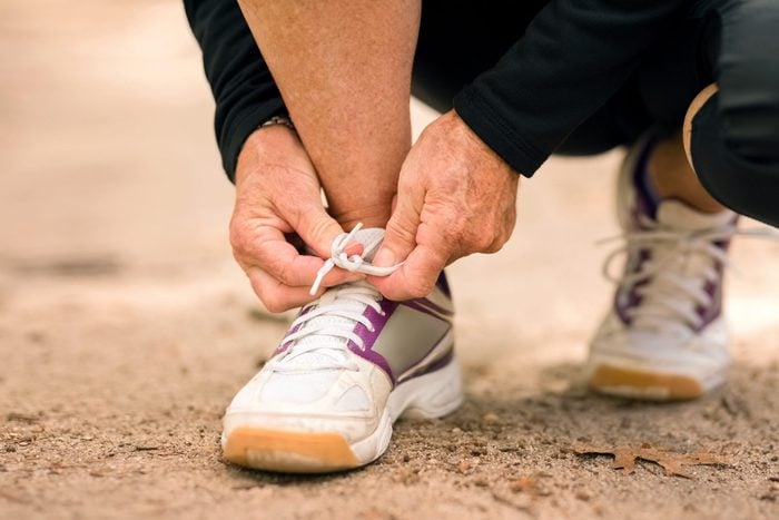 close up of person tying sneaker laces