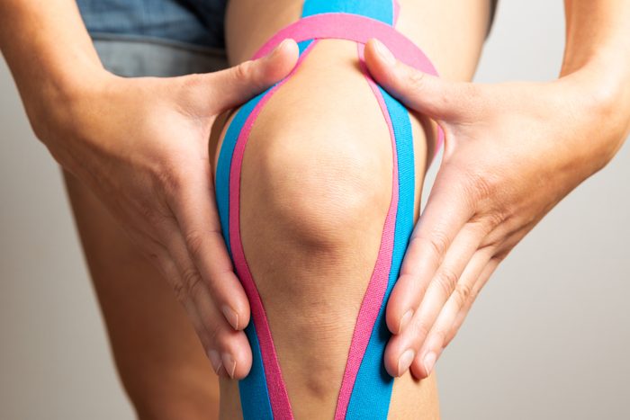 Female athlete with kinesio tape, muscle tape on knee
