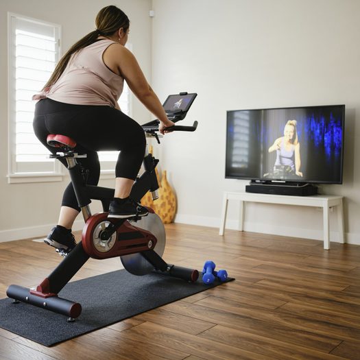 Woman Using Exercise Bike in a Home