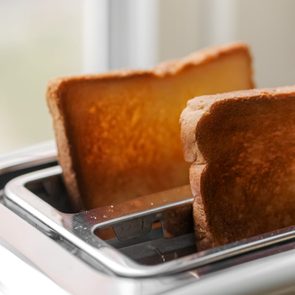 Toaster with ready bread slices in the kitchen. traditional breakfast at home