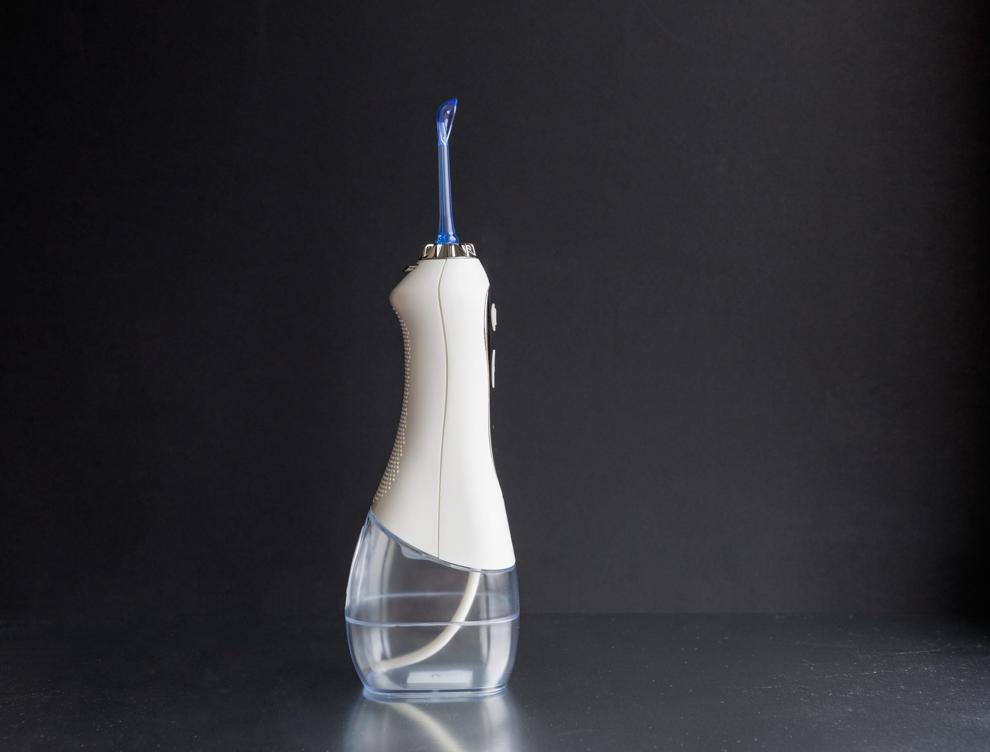 Time to brush your teeth. Oral irrigator on a black background