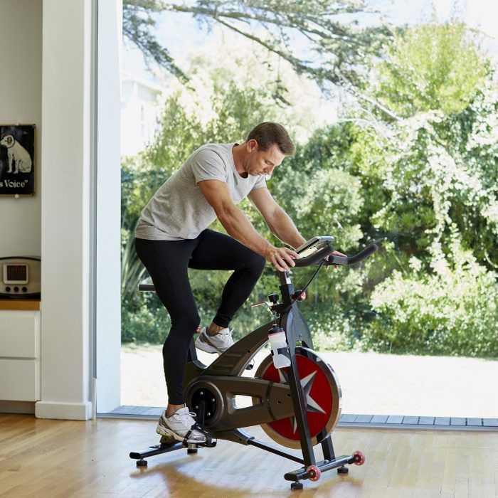 Man working out on exercise bike at home