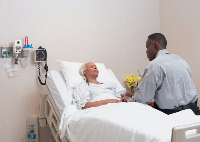 man visiting mother in hospital