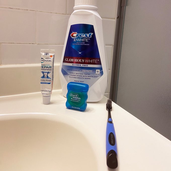 dental oral hygiene products on bathroom counter