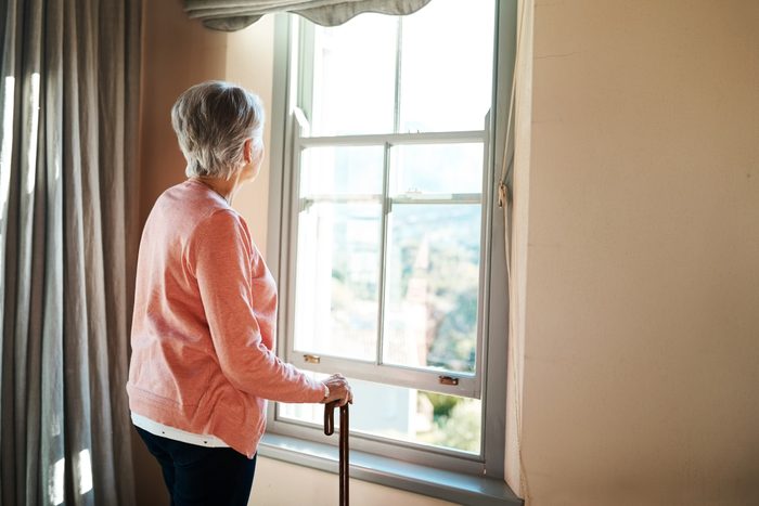 mature woman looking out window