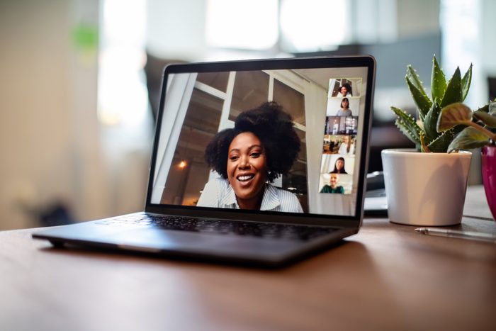 Businesswoman having a video call meeting with her team