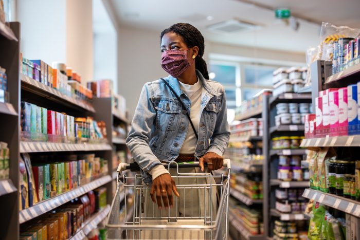 Female customer with face mask shopping at a grocery store
