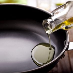 Pouring cooking oil in frying pan