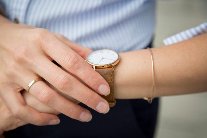 Businesswoman wearing wrist watch, close-up