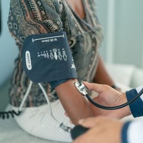 Mature adult woman has blood pressure checked