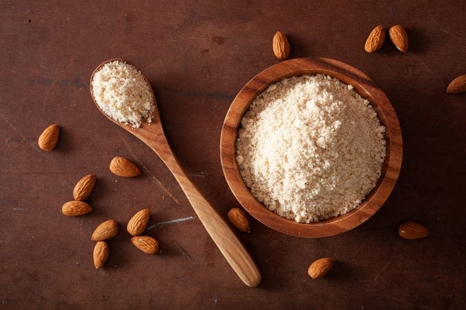 almond flour in wooden bowl and wooden spoon