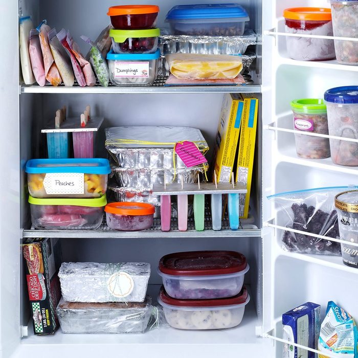 An organized freezer with lots of labeled airtight containers and bags.