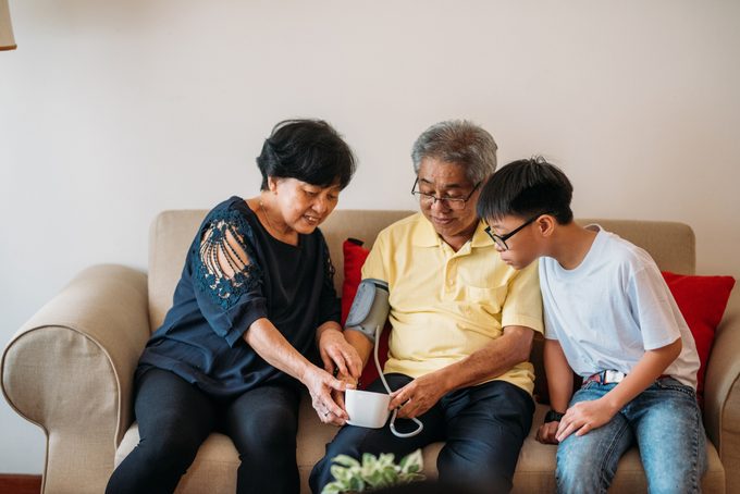 couple taking blood pressure with grandson