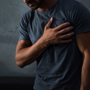 cropped view of man having chest pain and heart attack