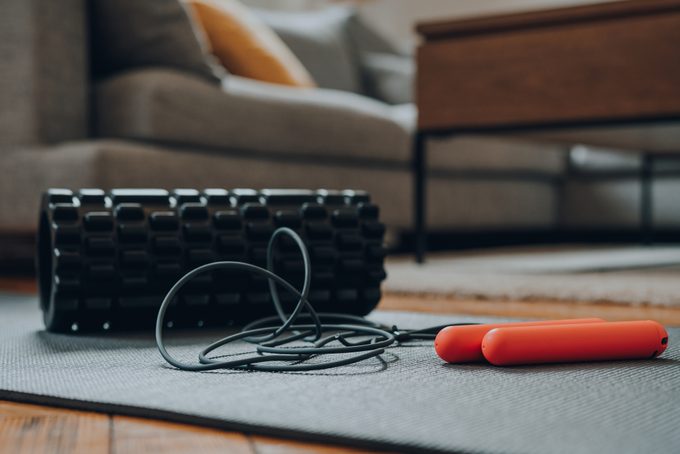 Close Up Of A Jump Rope And A Foam Roller On A Fitness Mat