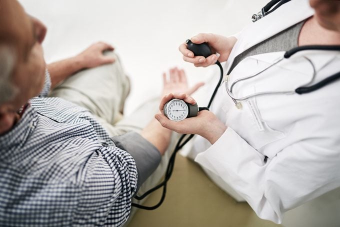 doctor measuring patient's blood pressure shot from above